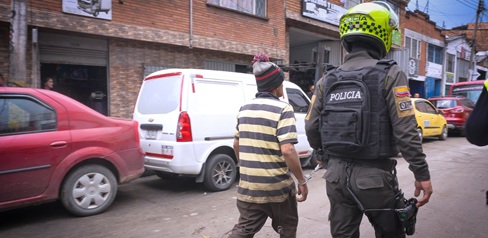 Un hombre caminando junto a un policía